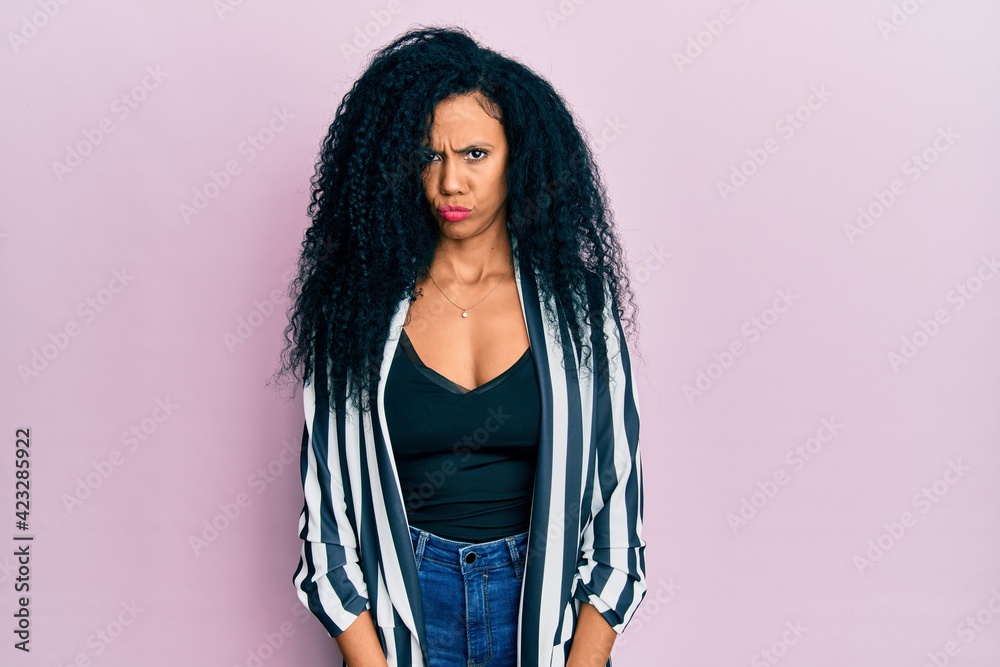 Middle age african american woman wearing casual clothes skeptic and nervous, frowning upset because of problem. negative person. Middle age african american woman wearing casual clothes skeptic and nervous, frowning upset because of problem. negative person.