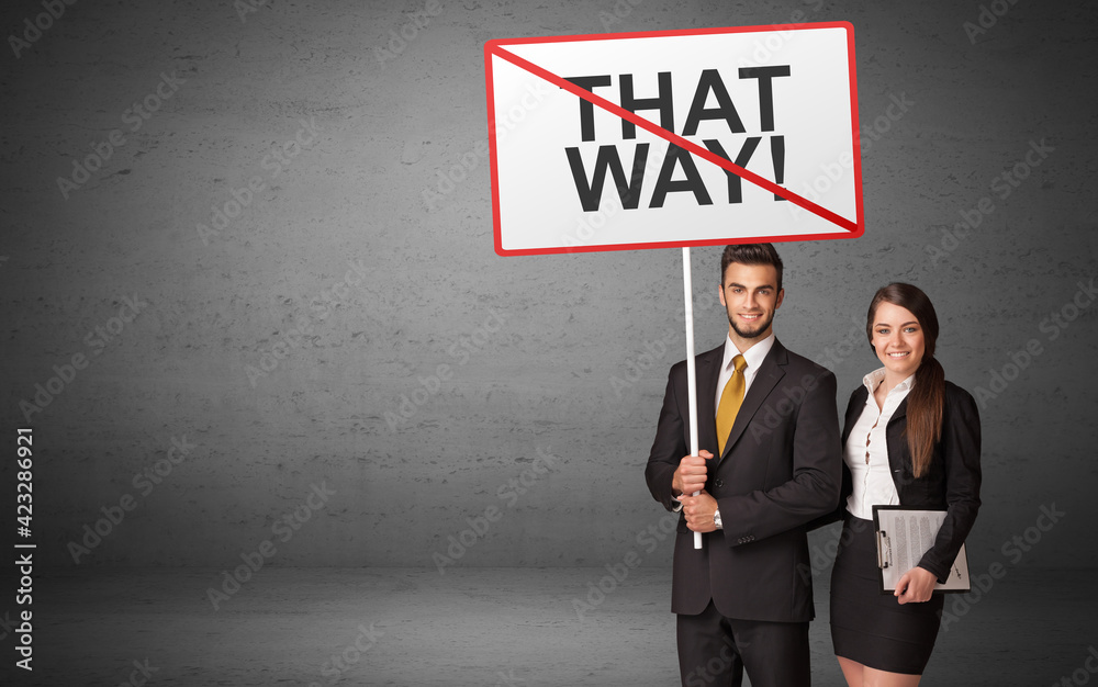 business person holding a traffic sign business person holding a traffic sign