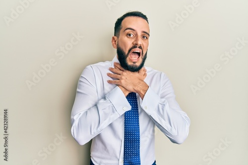 Young man with beard wearing business tie shouting and suffocate because painful strangle. health problem. asphyxiate and suicide concept.