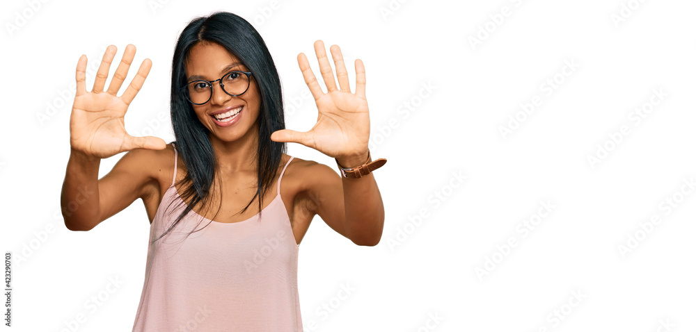 Young african american woman wearing casual clothes and glasses showing and pointing up with fingers number ten while smiling confident and happy. Young african american woman wearing casual clothes and glasses showing and pointing up with fingers number ten while smiling confident and happy.