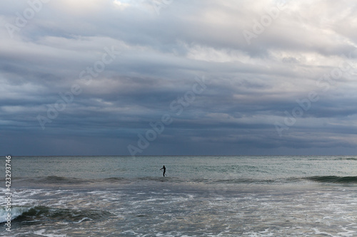 Seascape of the Mediterranean sea after a storm, surfers practicing bodyboar on the waves © adradaguajardo