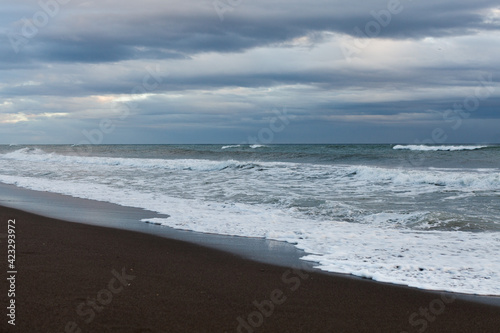 Seascape of the Mediterranean sea after a storm, surfers practicing bodyboar on the waves