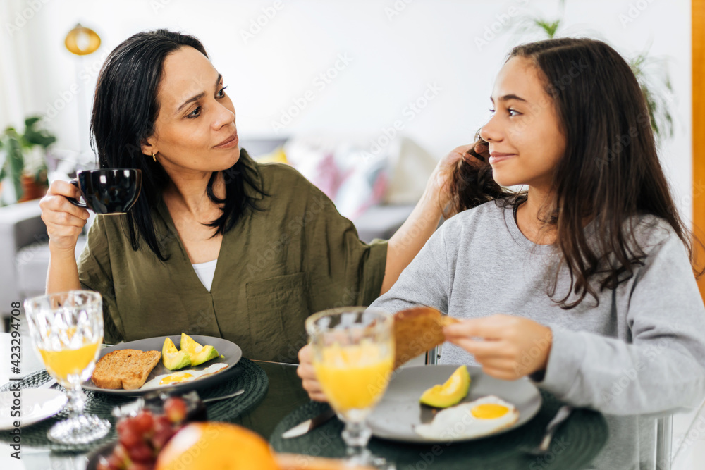 Single Parenthood. Mother and preteen daughter having breakfast at home. Single Parenthood. Mother and preteen daughter having breakfast at home.