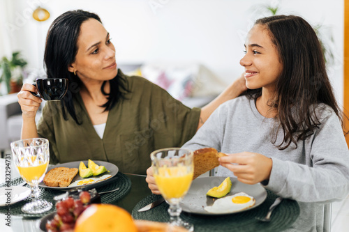 Single Parenthood. Mother and preteen daughter having breakfast at home.