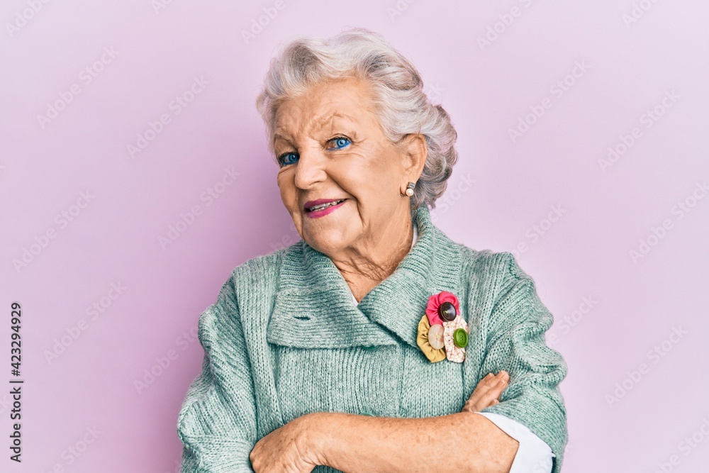 Senior grey-haired woman wearing casual clothes happy face smiling with crossed arms looking at the camera. positive person. Senior grey-haired woman wearing casual clothes happy face smiling with crossed arms looking at the camera. positive person.