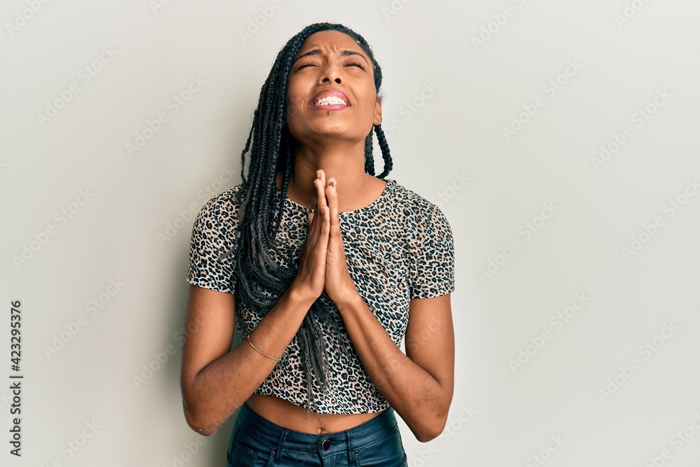 African american woman wearing casual clothes begging and praying with hands together with hope expression on face very emotional and worried. begging. African american woman wearing casual clothes begging and praying with hands together with hope expression on face very emotional and worried. begging.