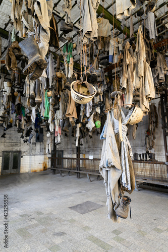 Fototapeta Naklejka Na Ścianę i Meble -  Mining clothes hung in a chain hook locker room.