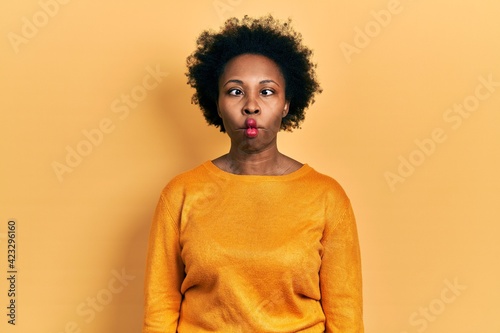Young african american woman wearing casual clothes making fish face with lips, crazy and comical gesture. funny expression. © Krakenimages.com