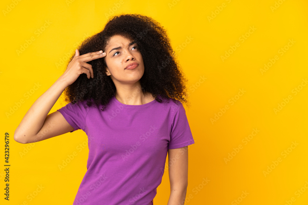 Young african american woman over isolated background with problems making suicide gesture Young african american woman over isolated background with problems making suicide gesture