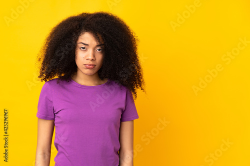 Young african american woman over isolated background with sad expression