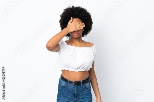 Young African American woman isolated on white background covering eyes by hands. Do not want to see something