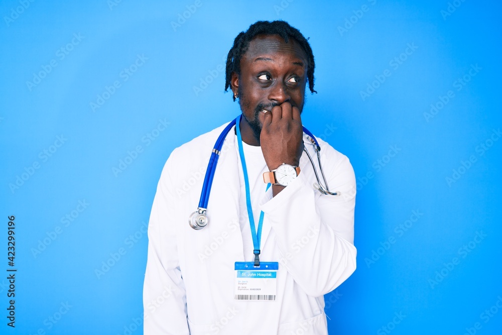 Young african american man with braids wearing doctor stethoscope and id pass looking stressed and nervous with hands on mouth biting nails. anxiety problem.