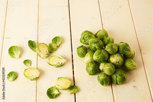 Bunch of fresh raw Brussel sprouts on a white wood table