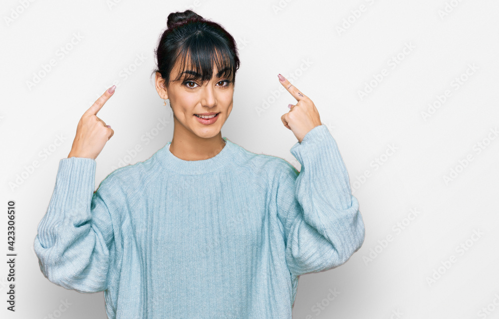 Young hispanic woman wearing casual clothes smiling pointing to head with both hands finger, great idea or thought, good memory