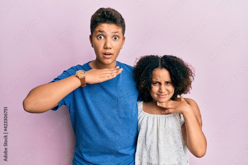Young hispanic family of brother and sister wearing casual clothes together cutting throat with hand as knife, threaten aggression with furious violence Young hispanic family of brother and sister wearing casual clothes together cutting throat with hand as knife, threaten aggression with furious violence