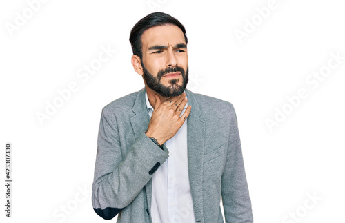 Young hispanic man wearing business clothes touching painful neck, sore throat for flu, clod and infection