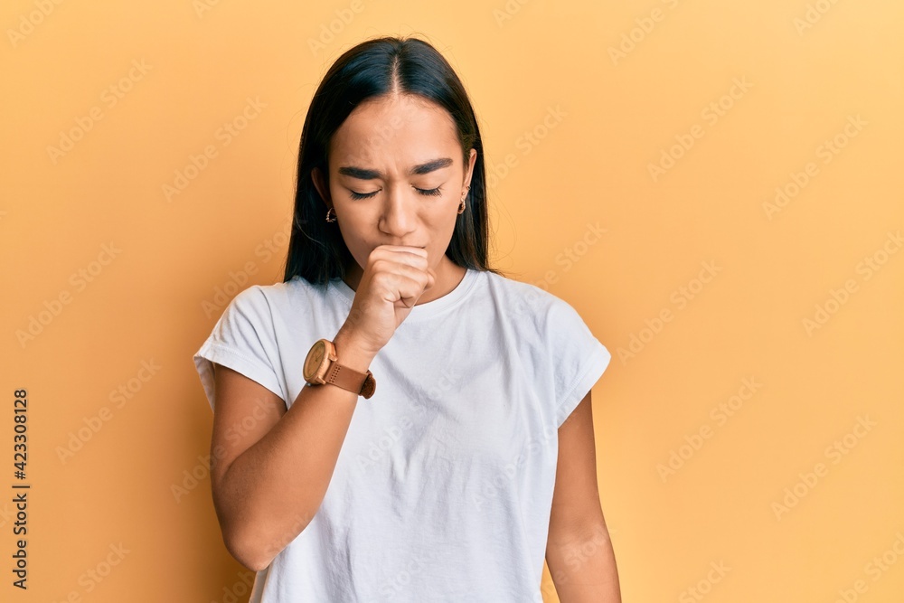 Young asian woman wearing casual white t shirt feeling unwell and coughing as symptom for cold or bronchitis. health care concept. Young asian woman wearing casual white t shirt feeling unwell and coughing as symptom for cold or bronchitis. health care concept.