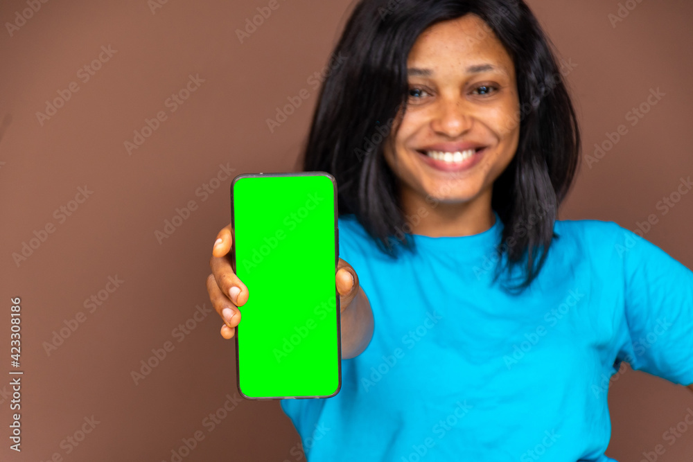 beautiful black lady showing her phone screen to the camera, screen is blank and green, for advertising beautiful black lady showing her phone screen to the camera, screen is blank and green, for advertising