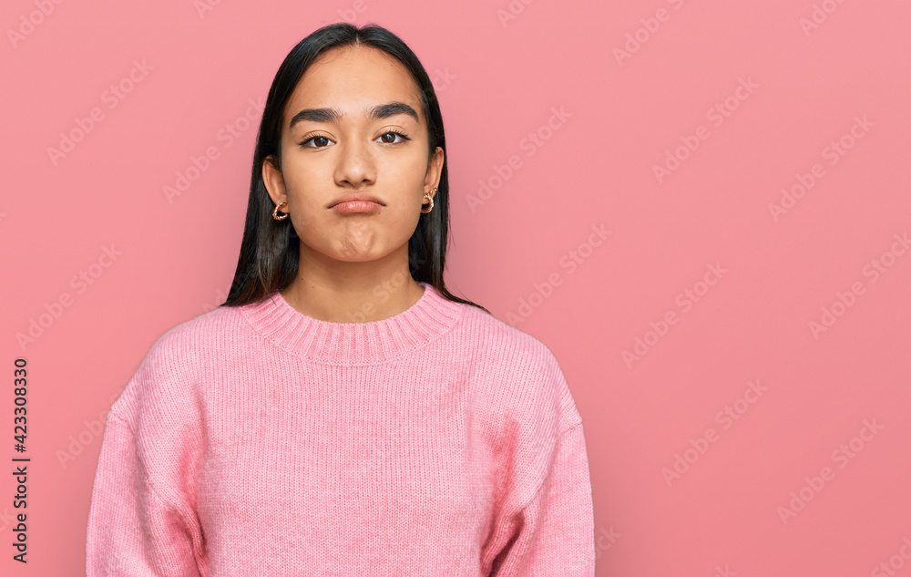 Young asian woman wearing casual winter sweater looking sleepy and tired, exhausted for fatigue and hangover, lazy eyes in the morning.