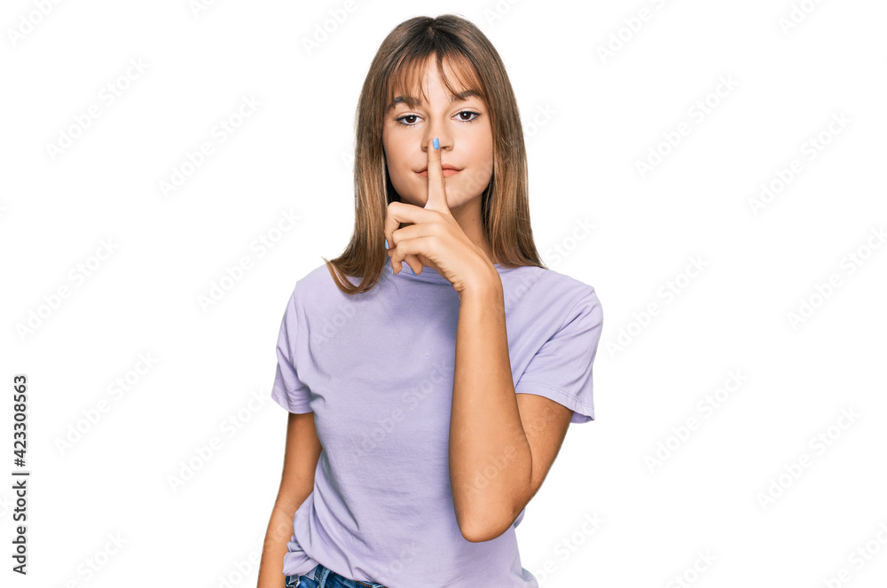 Teenager caucasian girl wearing casual clothes asking to be quiet with finger on lips. silence and secret concept. Teenager caucasian girl wearing casual clothes asking to be quiet with finger on lips. silence and secret concept.