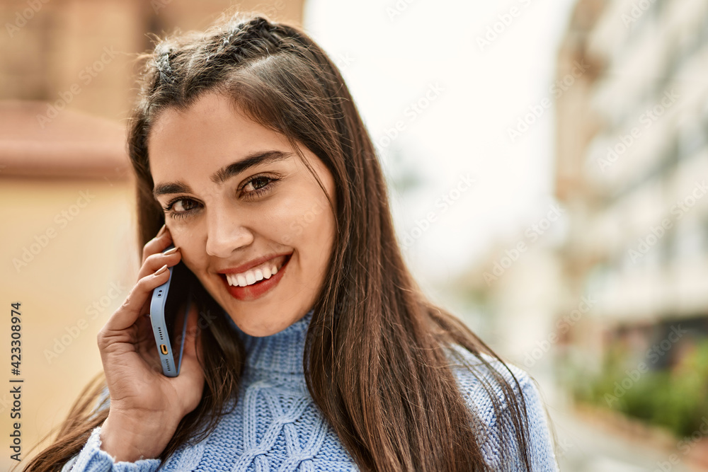 Young hispanic girl smiling happy talking on the smartphone at the city Young hispanic girl smiling happy talking on the smartphone at the city