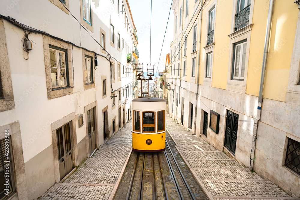 Famous yellow tram in Lisbon old town, Portugal. Tourist attraction in city centre