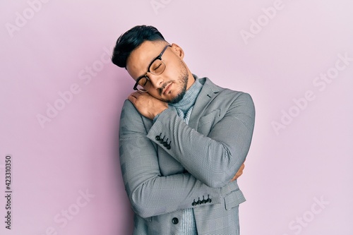 Young arab man wearing business clothes hugging oneself happy and positive, smiling confident. self love and self care © Krakenimages.com