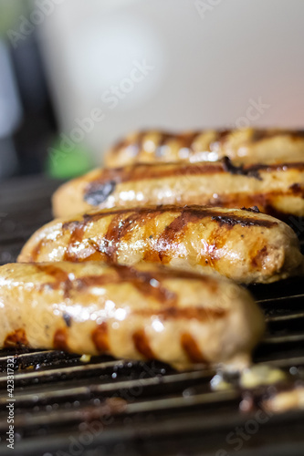 grilled pork sausages lie in a row on the grill selective focus