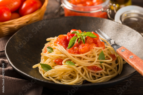 Spaghetti with tomato sauce and basil.