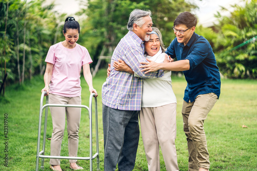 Portrait enjoy happy smiling love multi-generation asian big family.Senior mature father and elderly mother with young adult woman and young man son on walking outdoor in park at home.insurance  © Art_Photo