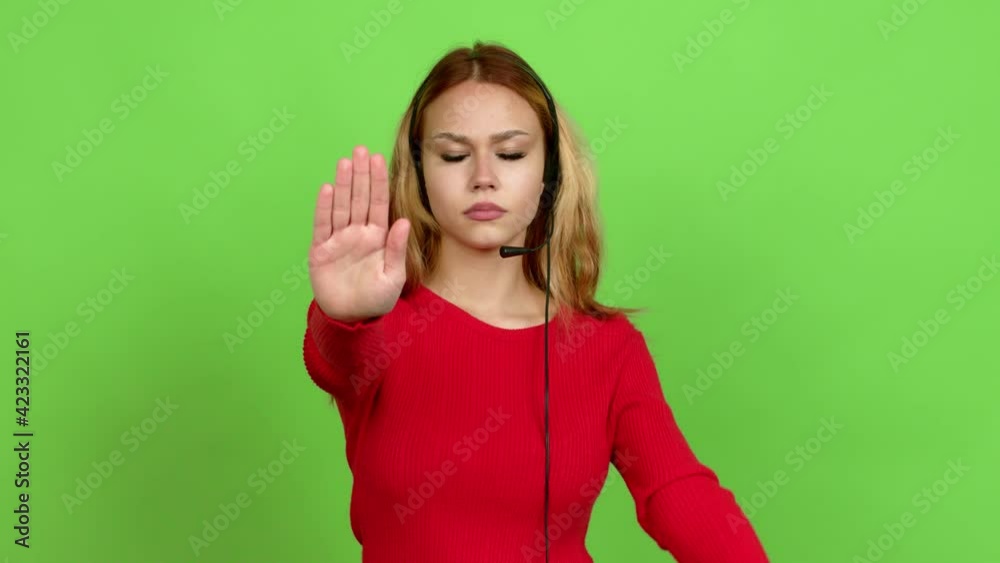 Young blonde teenager girl telemarketer doing stop sign over isolated background. Green screen chroma key Young blonde teenager girl telemarketer doing stop sign over isolated background. Green screen chroma key