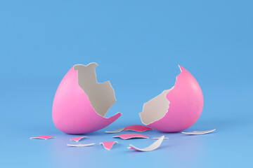 Pink Easter egg cracked open and broken into pieces.