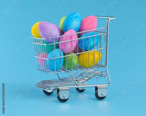 Colorful Easter eggs piled in shopping cart for Easter shopping.