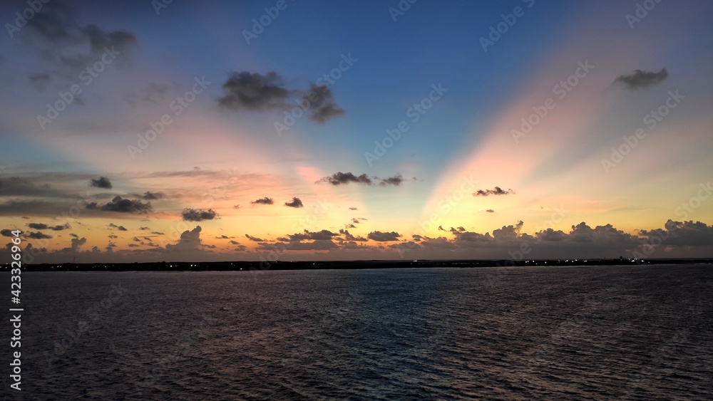 Sunbeams through horizon over the Caribbean