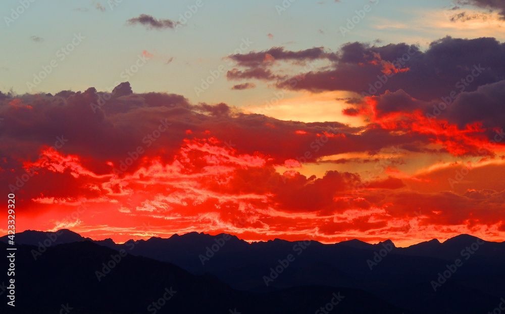 spectacular sunset over long's peak and the front range of the colorado rocky mountains as seen form broomfield, colorado