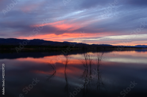Sun setting over a calm lake in Nevada's desert