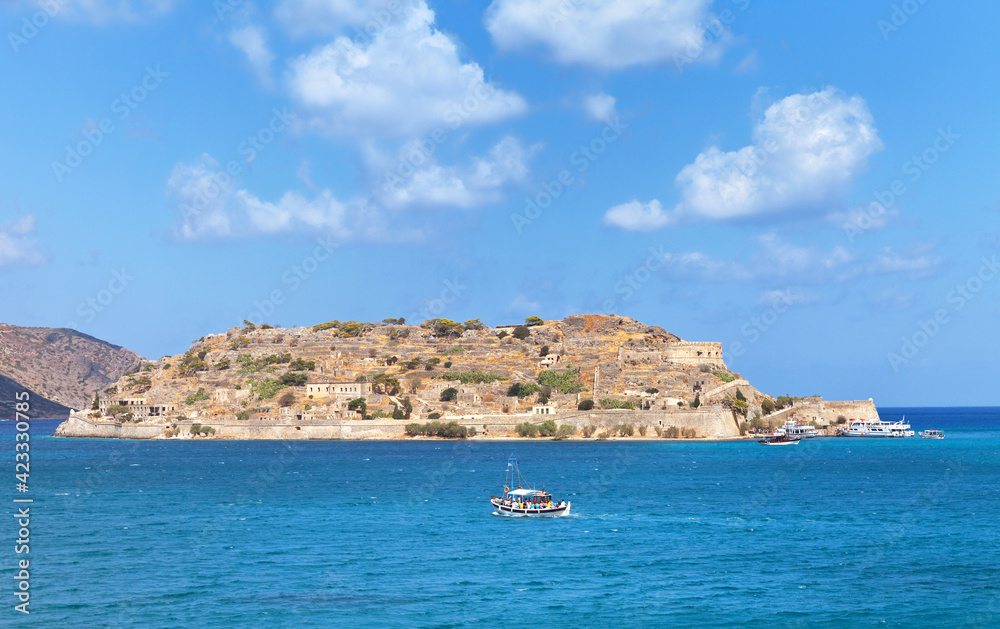 Greece island Crete. A beautiful view from the sea to the island of Spinalonga with Venetian defensive fortress of 1579 - tourist landmark and place of attraction for travelers. Summer holidays