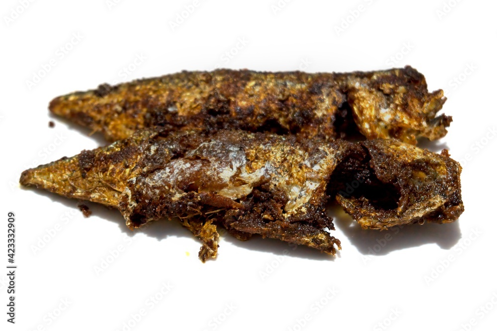 Indian mackerel fried with various spices and pepper in Kerala cuisine style, traditionally known as Ayala Varuthathu, isolated on a white background. Indian mackerel fried with various spices and pepper in Kerala cuisine style, traditionally known as Ayala Varuthathu, isolated on a white background.