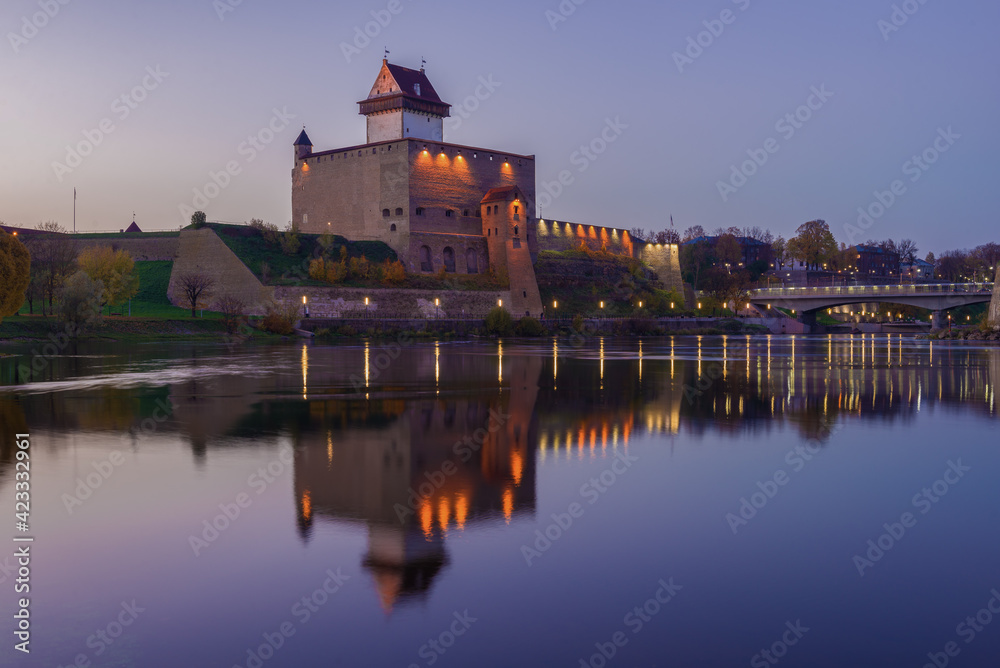View of the Herman Castle in the lilac October twilight. Narva, Estonia
