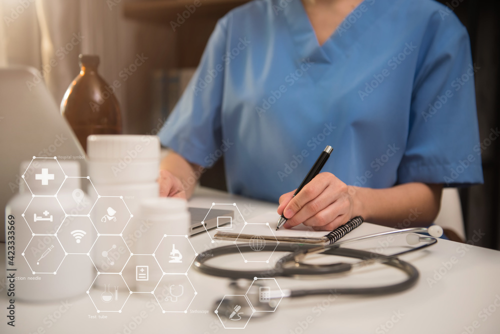 Doctor working on laptop computer and tablet and medical stethoscope on clipboard on desk. Doctor working on laptop computer and tablet and medical stethoscope on clipboard on desk.