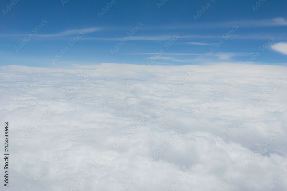 over the clouds,Blue sky with tiny clouds background Beautiful natural view from airplane window above. Background or Wallpaper.blue sky and cloud sky nature.Top view of aircraft