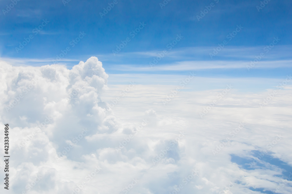 Naklejka premium over the clouds,Blue sky with tiny clouds background Beautiful natural view from airplane window above. Background or Wallpaper.blue sky and cloud sky nature.Top view of aircraft