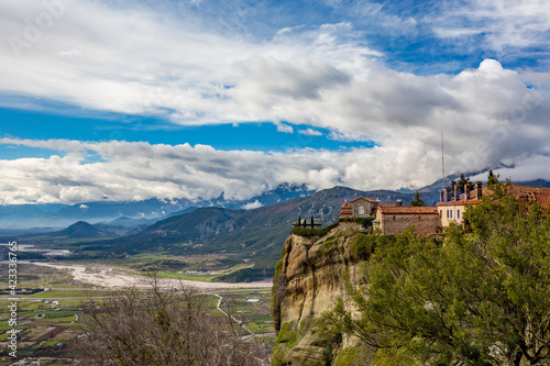 Meteora, Greece, Early spring landscape of the cliffs, monastery, curvy road and cloudy sky. Early spring view, travel photo