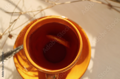 cup of black tea with lemon slice at early morning