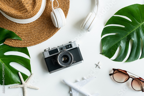 Flat lay of traveler accessories on white desk. Summer, holiday and planning a trip concepts. Top view