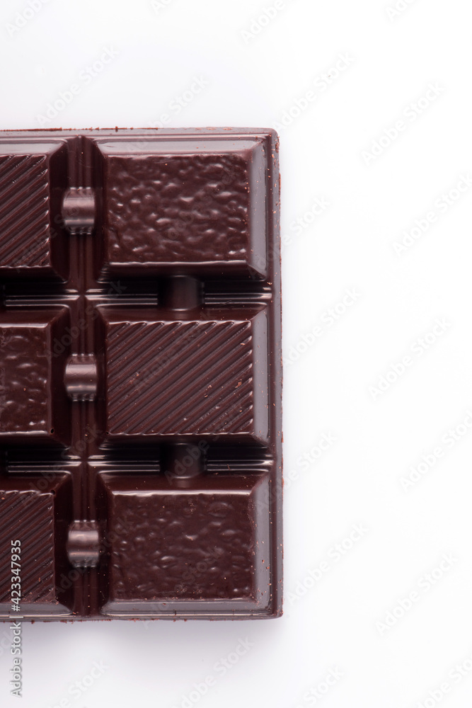 Obraz premium Broken dark chocolate broken stack isolated on white background