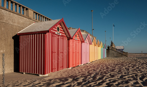 Beach cabins with vibrant colors on the French coast. Perspective view.