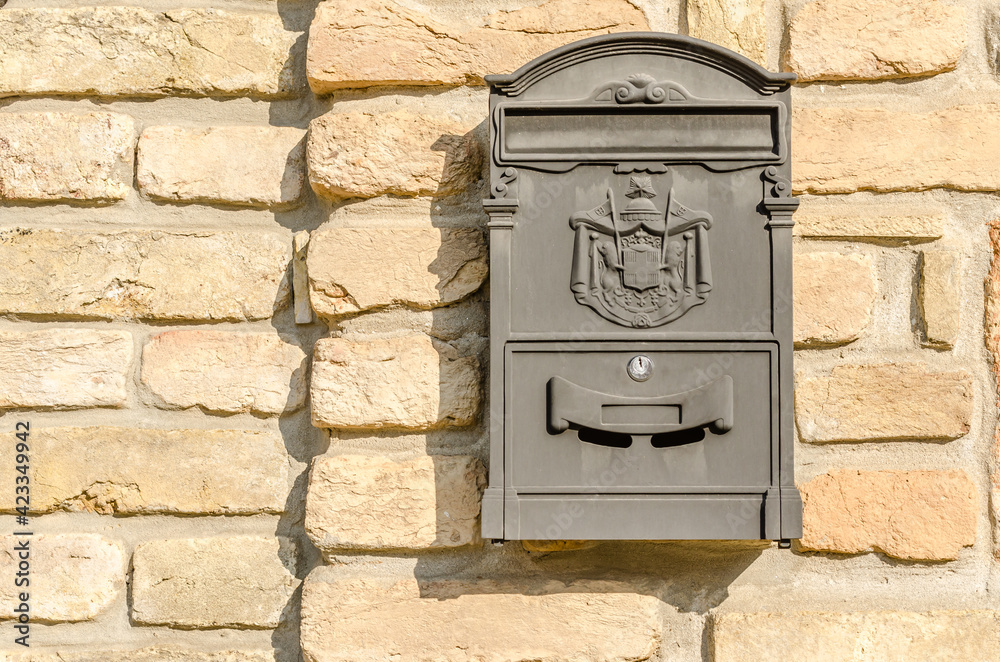 Hanging ornamental mailbox on the facade of the house Hanging ornamental mailbox on the facade of the house