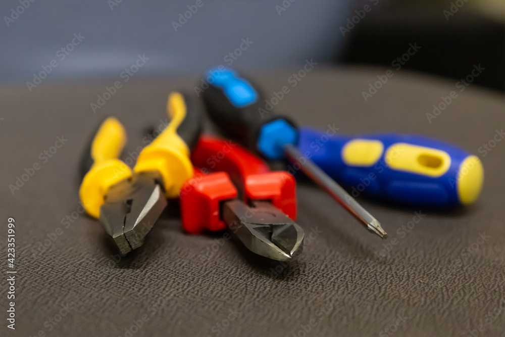 Fototapeta premium yellow pliers tool set red nippers and two blue screwdrivers