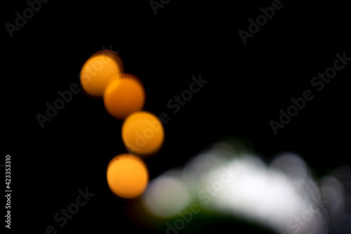 Take a close-up photo with blurred style, 4 lights Represents the light in the dark Isolated on black background.